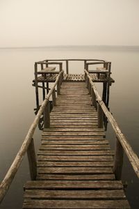 Pier over sea against clear sky