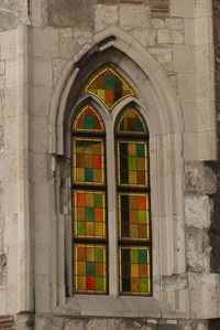 Exterior of historic building seen through closed window