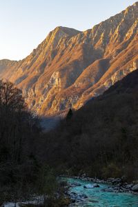 Scenic view of land and mountains against sky