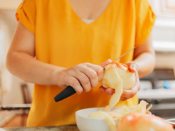 Peeling apple with knife 