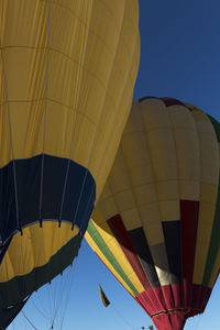 Low angle view of hot air balloon flying against sky