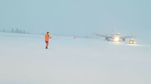 Man in ski lift against clear sky