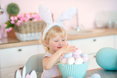 Portrait of cute girl playing with easter egg