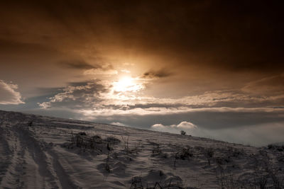 Scenic view of snowcapped mountains against sky during sunset