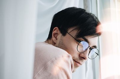 Close-up portrait of man wearing eyeglasses