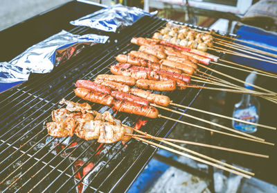 High angle view of meat on barbecue grill