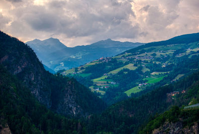 Sunset over the mountains in trentino alto adige with vineyards and orchards