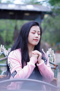 Beautiful woman praying outdoors