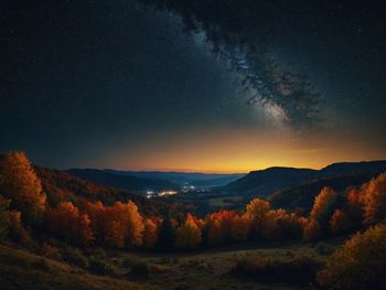 Scenic view of mountains against sky at night