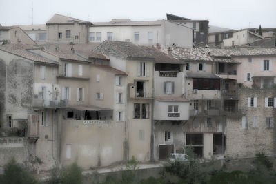 Residential buildings in city against clear sky
