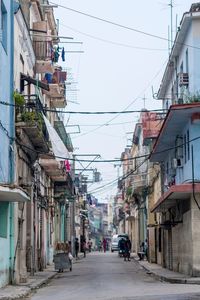 Street amidst buildings in city against sky