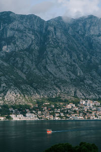 Scenic view of sea and mountains against sky