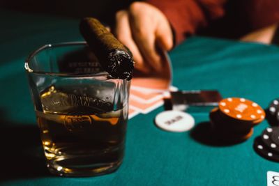 Close-up of alcohol with cigar on table