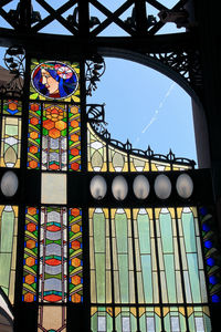 Low angle view of multi colored glass building