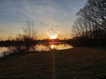 Scenic view of lake against sky during sunset