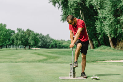 Full length of man standing on golf course