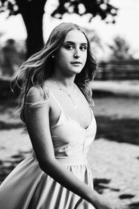 Portrait of beautiful young woman lying on land