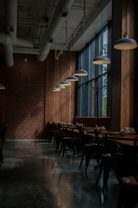 Empty chairs and tables in illuminated building