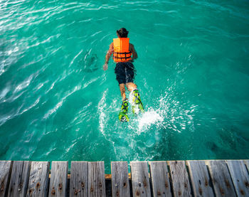 Rear view of man in sea