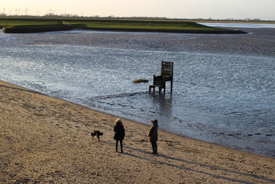 People on beach against sky