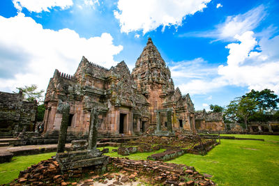 Old temple building against cloudy sky