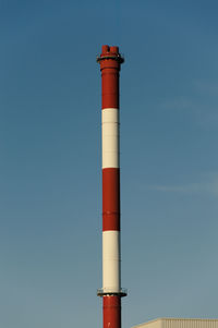 Low angle view of lighthouse against clear blue sky