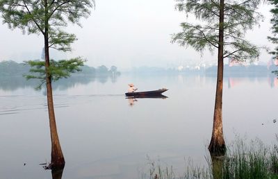 Person sitting on boat at river