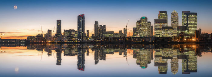 Reflection of buildings in city at waterfront