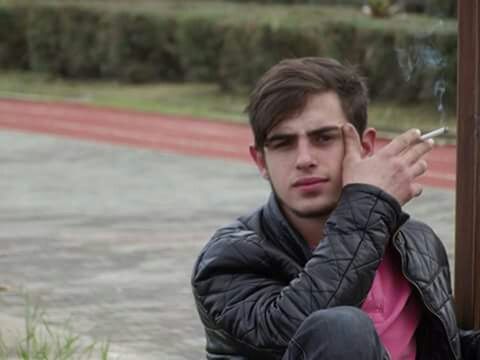 lifestyles, focus on foreground, person, leisure activity, young adult, casual clothing, smiling, portrait, headshot, looking at camera, waist up, happiness, head and shoulders, sitting, young men, front view