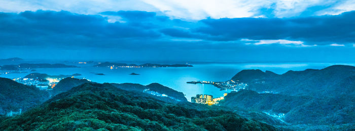 Panoramic view of sea and mountains against sky