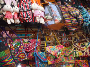 Multi colored umbrellas hanging for sale at market stall