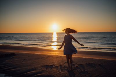 Woman on beach during sunset