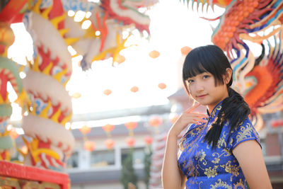 Portrait of young woman standing outdoors