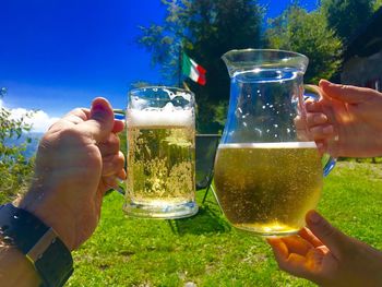 Midsection of people holding drink