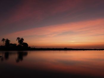 Scenic view of lake against romantic sky at sunset