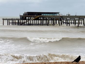 Pier over sea against clear sky