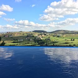 Swimming pool by mountains against sky