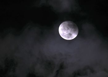 Low angle view of moon against sky at night