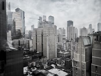 High angle view of buildings in city against sky