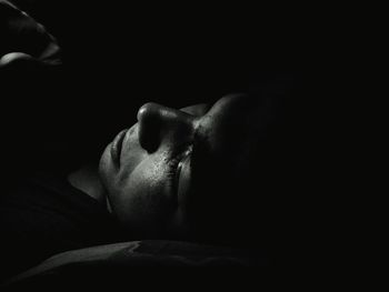 Close-up of man sleeping on bed