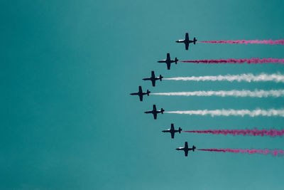 Low angle view of airplane flying against clear sky