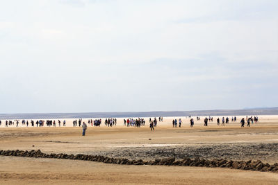 People on land against sky