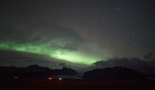 Scenic view of mountains against sky at night