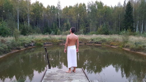 Rear view of man standing by trees