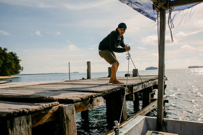 Man standing by sea against sky