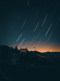 Silhouette buildings against sky at night