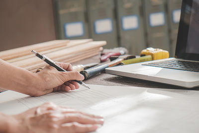 Cropped image of man working on table