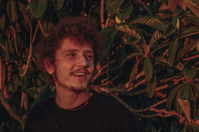 Portrait of young man looking at plants