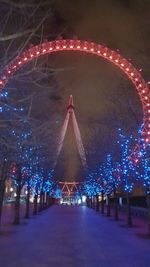 Illuminated ferris wheel at night