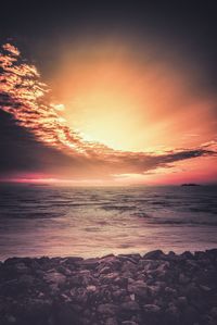 Scenic view of sea against romantic sky at sunset